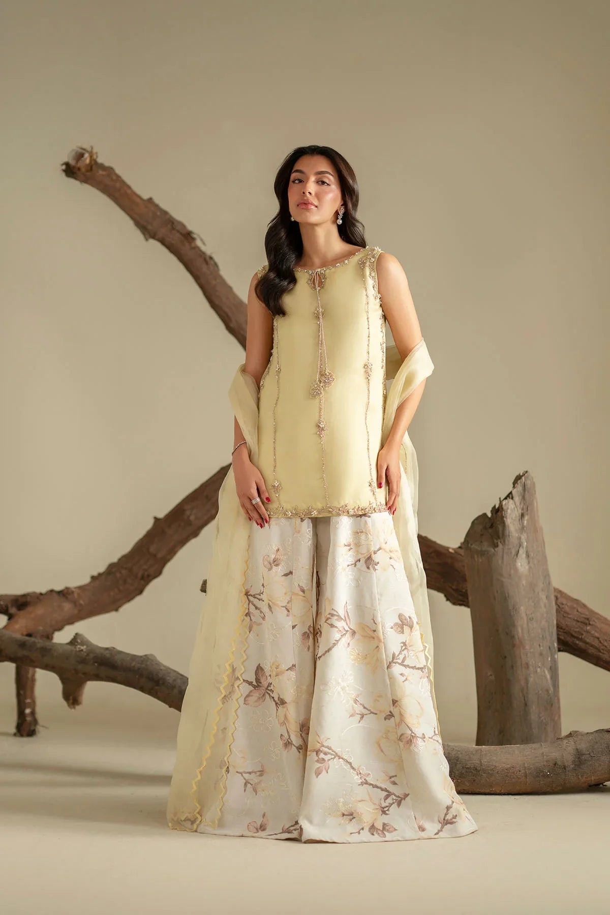 Model wearing a light yellow embroidered Pakistani Eid dress with floral sharara – Momin Fabric